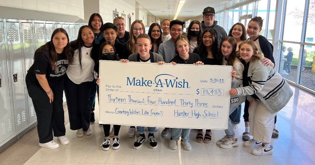 Hunter High School student leaders holding a Make-A-Wish Utah check for 13,433 dollars