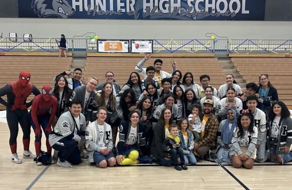 Hunter High School student group photo with a Make-A-Wish family and Spider-Man characters